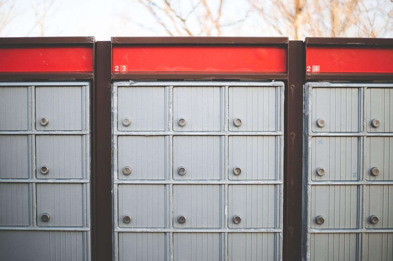 services-02 Image of secure outdoor community mailboxes with individual lockers in a row.